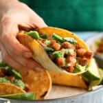 a hand holding one chickpea taco.