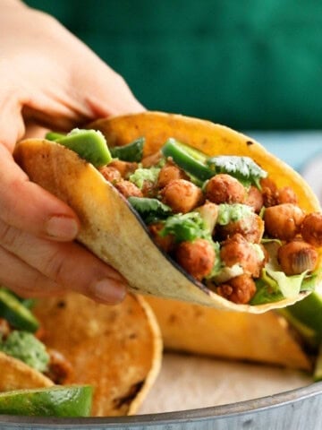 a hand holding one chickpea taco.