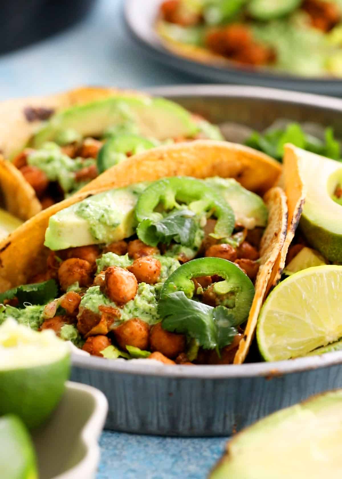 3 chickpea tacos in a metal tray.