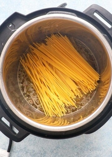 raw spaghetti placed in an instant pot.