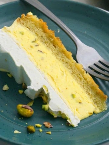 one slice of kulfi cake in a green plate.