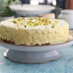 one yellow kulfi ice cream cake in a white cake stand.