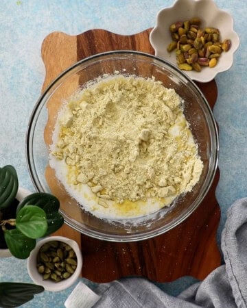 pistachio cake batter in a glass bowl.