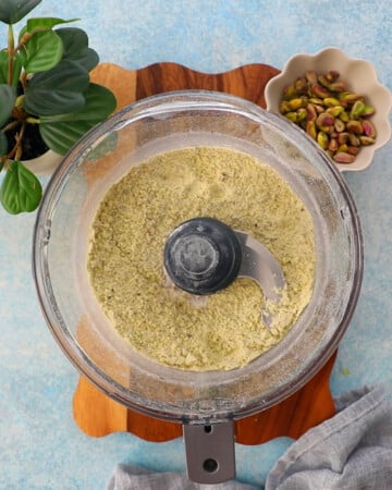 green pistachio cake batter in a food processor.