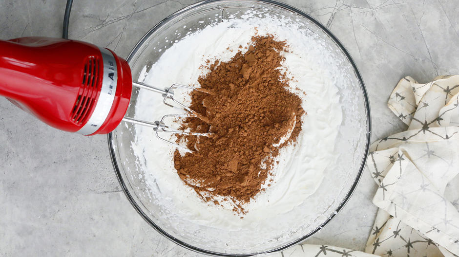Add cocoa powder to whipped cream