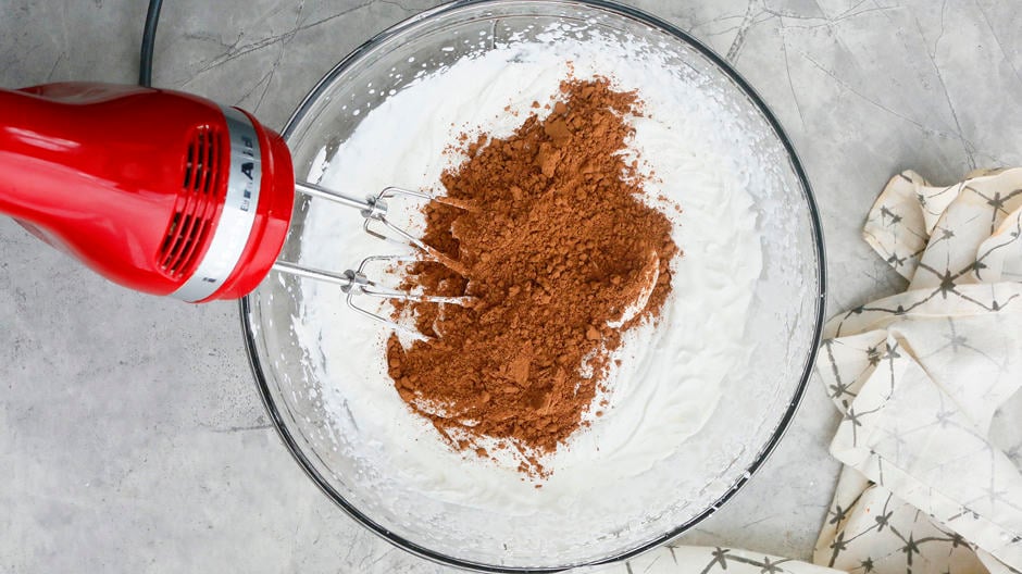 Add cocoa powder to whipped cream