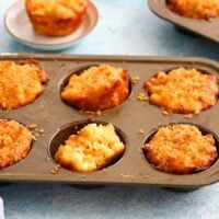 baked mac and cheese cups in a metal muffin pan.