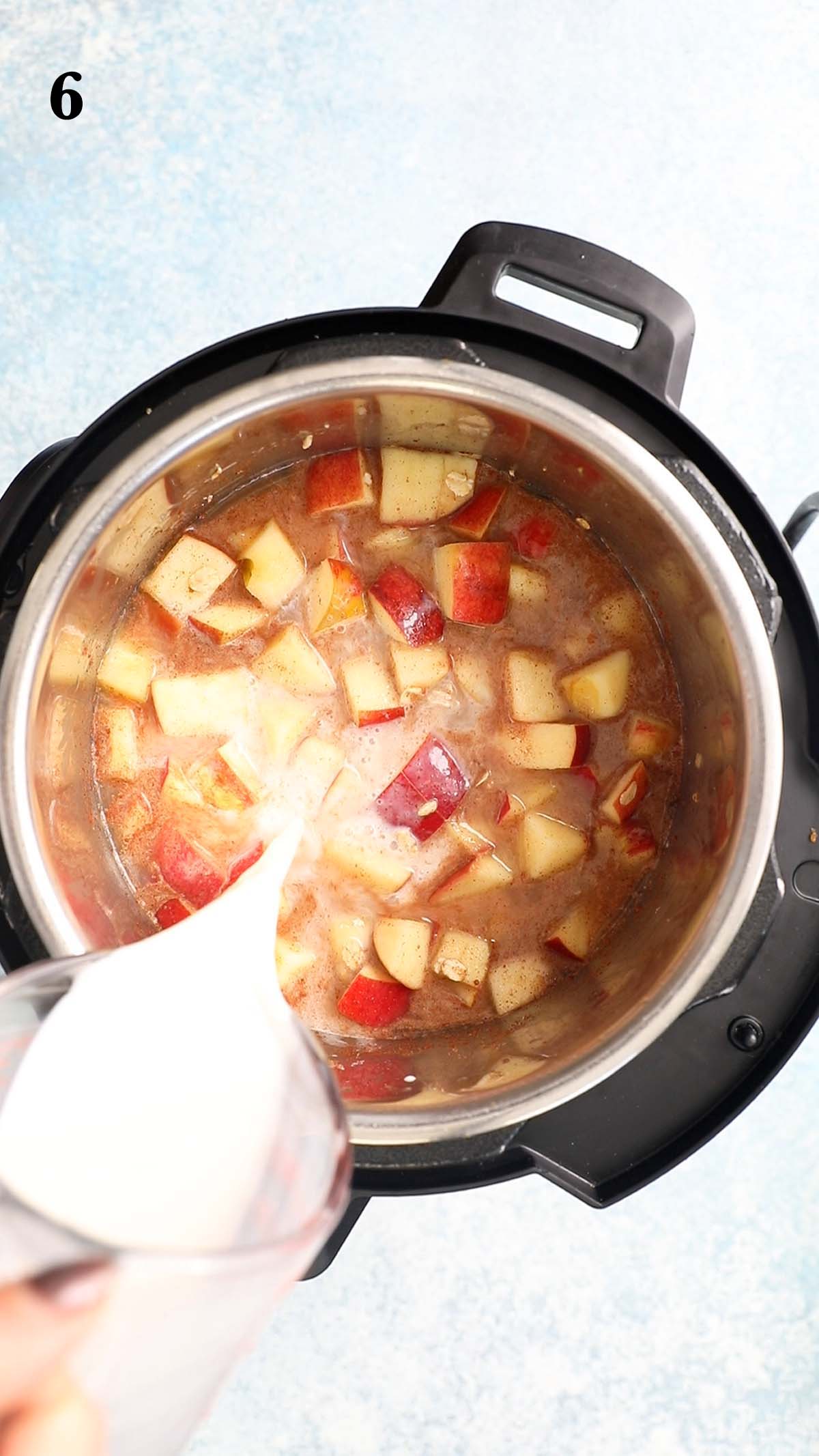 pouring milk into an instant pot with chopped apple and oat mixture.