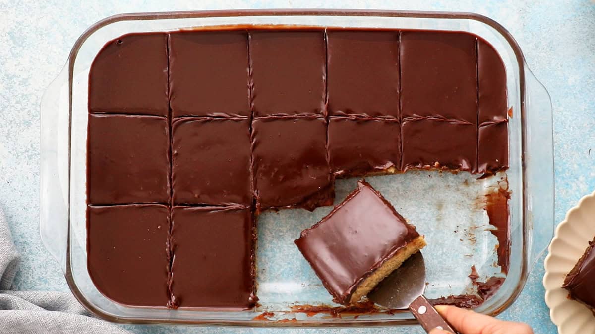 brown chocolate topped banana cake in a glass dish.