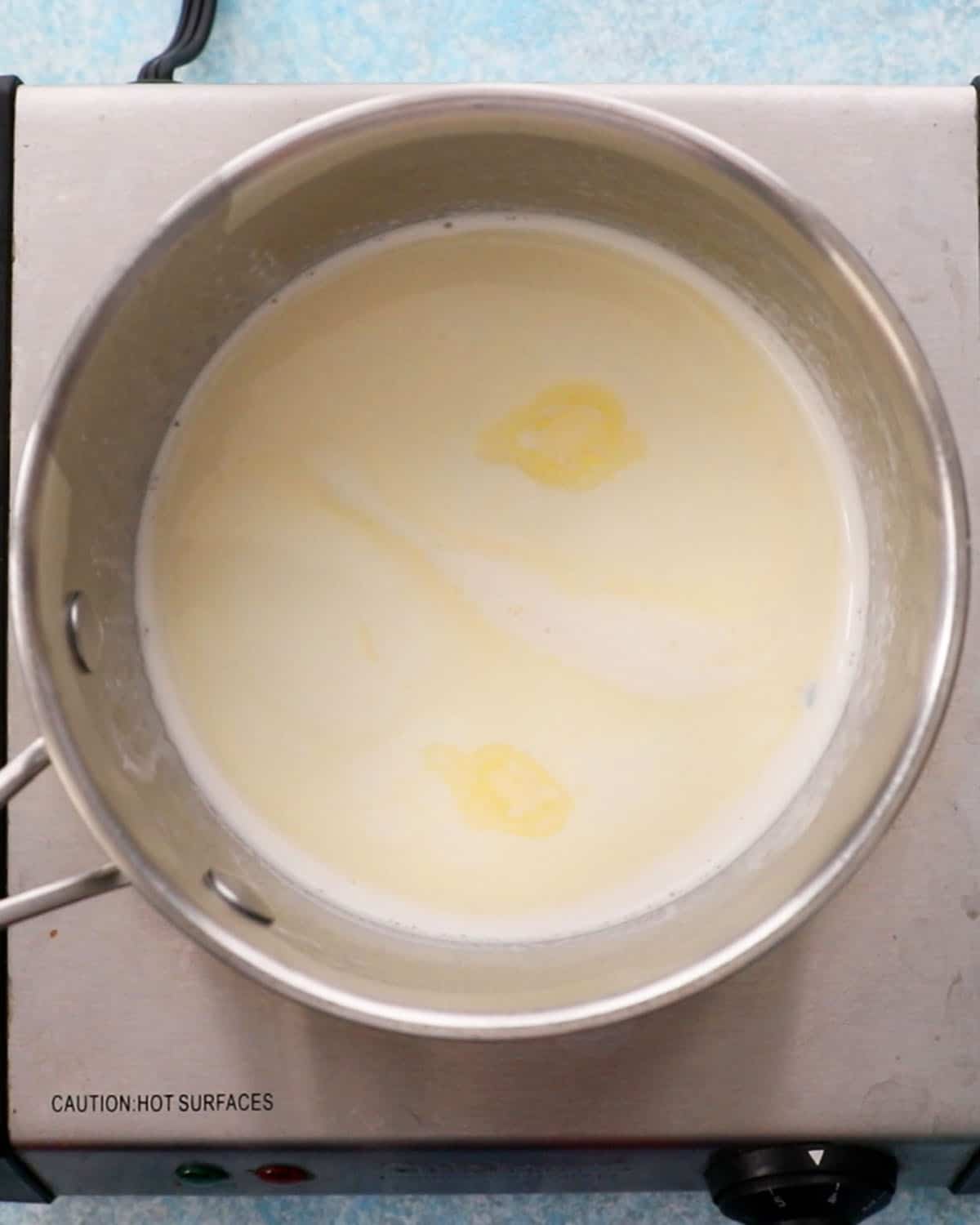 white cream in a stainless steel pot.