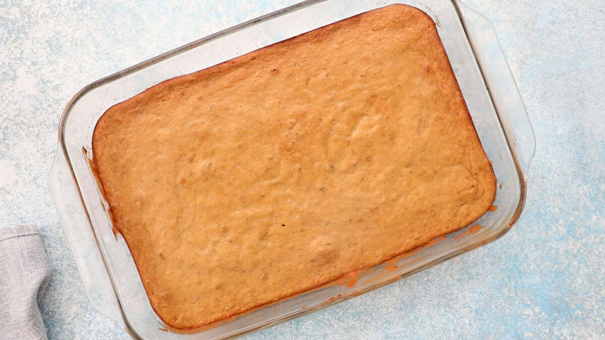 baked brown banana cake in a glass baking dish.