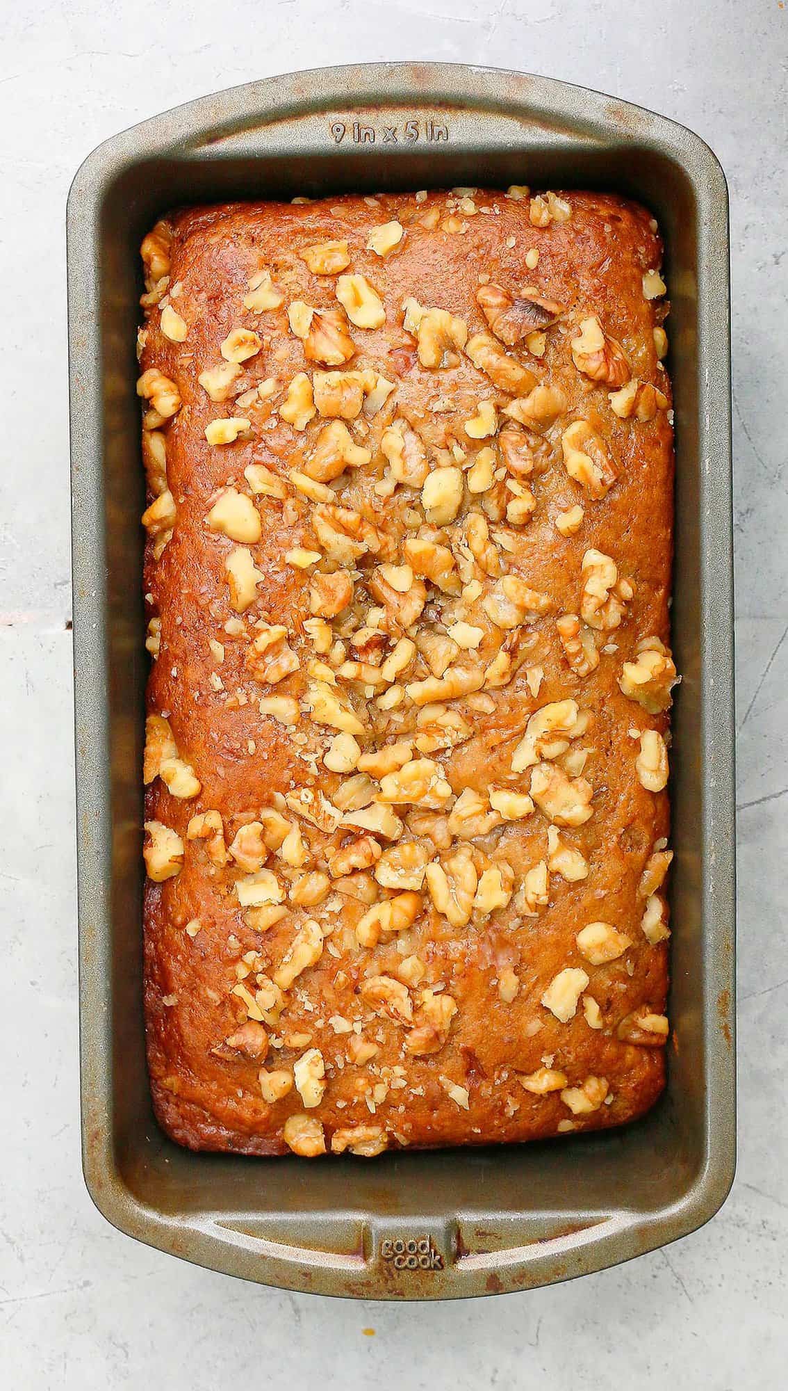 metal loaf pan with baked banana bread.