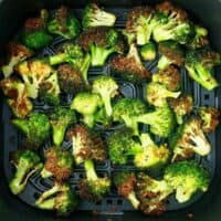 air fried broccoli in a black basket.