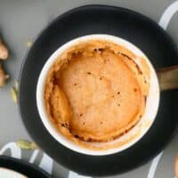 cooked chai mug cake in a white mug.