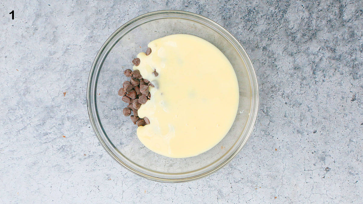 one glass bowl with chocolate chips and condensed milk.