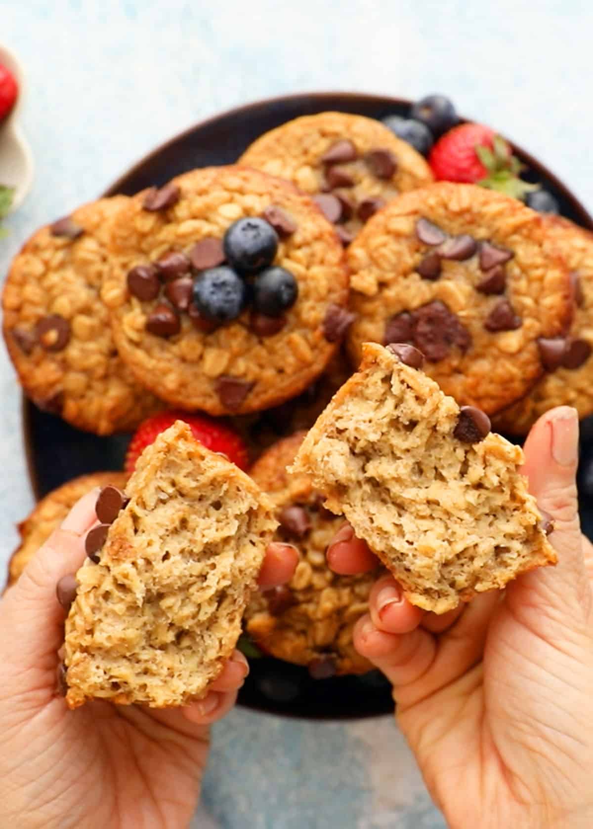two hands holding two halves of a oatmeal cup.