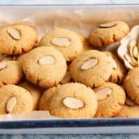 round almond cookies placed in a white tray.