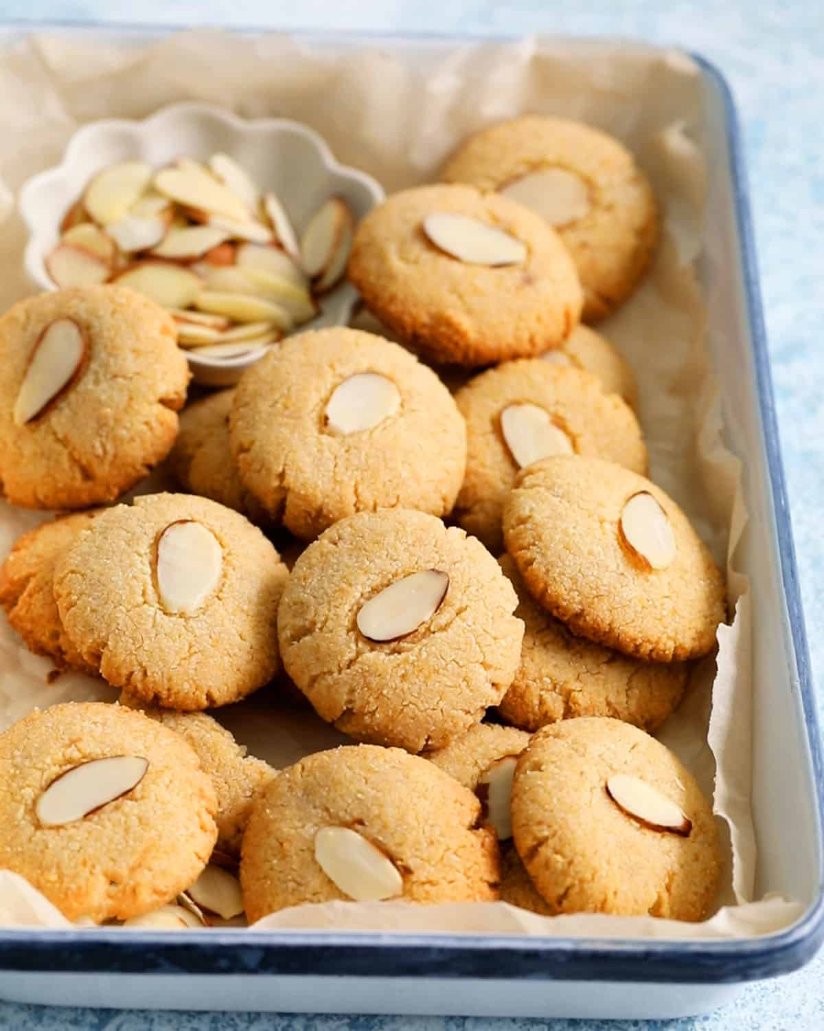 round almond cookies placed in a white tray.