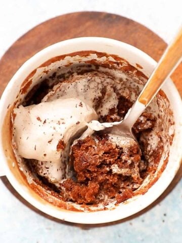 white mug with mocha cake and a spoon.