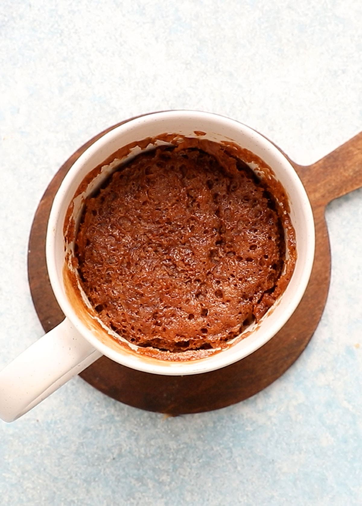 one white mug with brown cake.