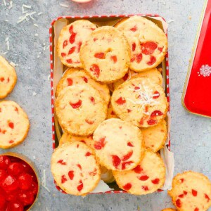 a red box filled with cherry cookies.