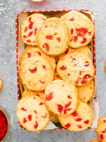 a red box filled with cherry cookies.