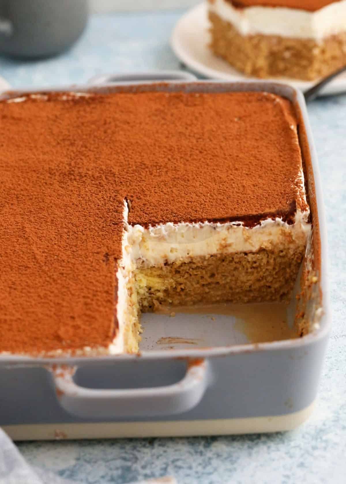 baked tres leches cake in a grey rectangular baking pan.