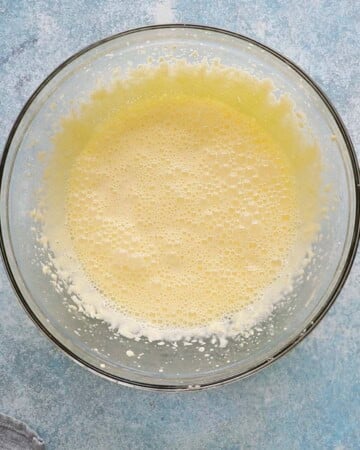 beaten yellow wet cake batter in a large glass bowl.