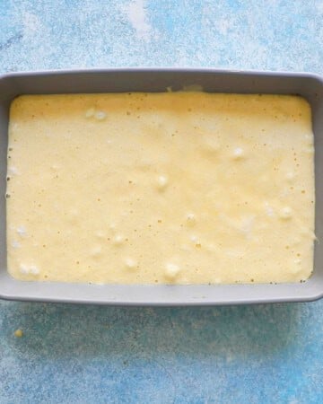 tres leches cake batter in a rectangular grey pan.