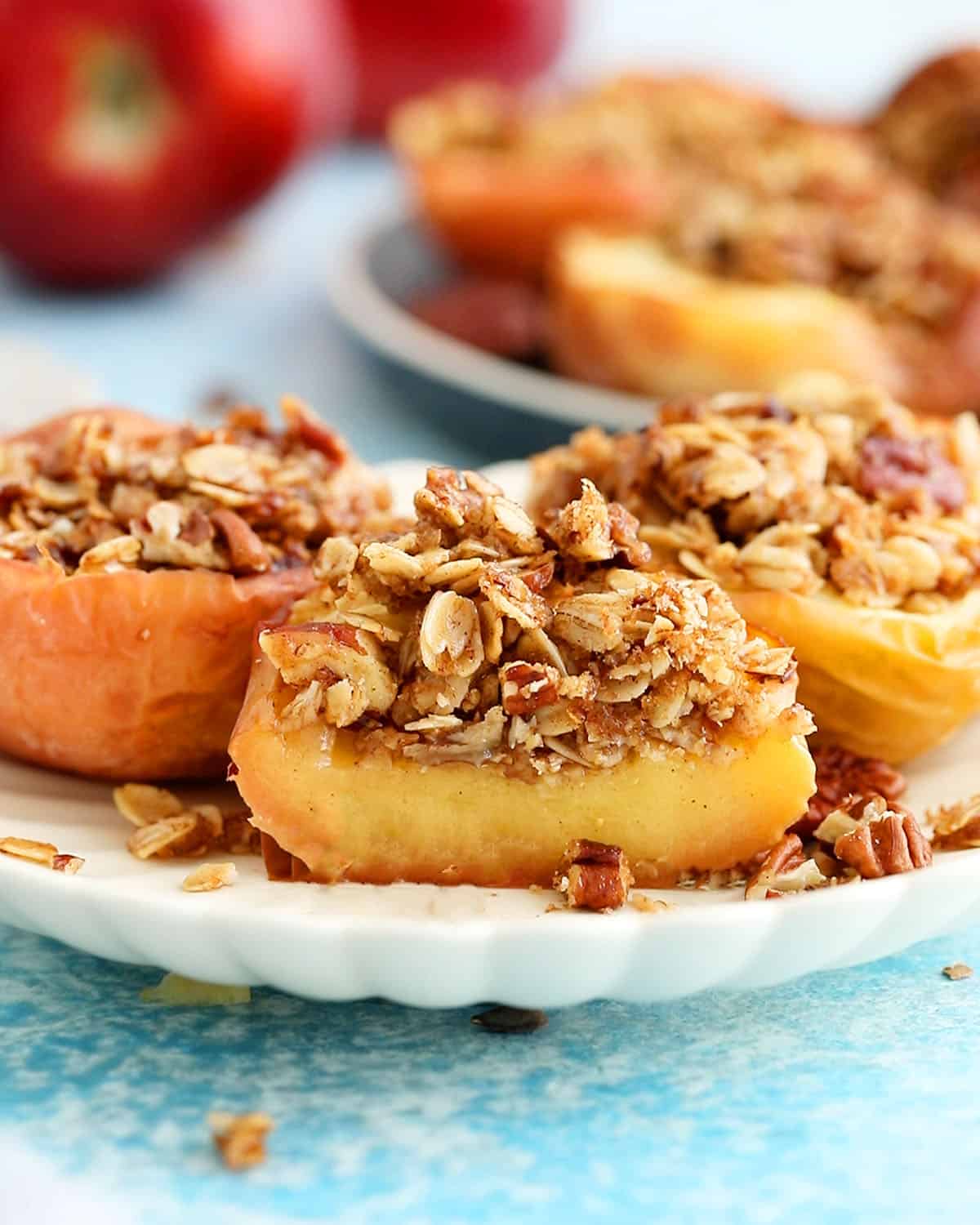 3 air fried apple halves in a white plate.