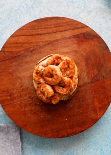 cooked red shrimp placed on top of a bun.