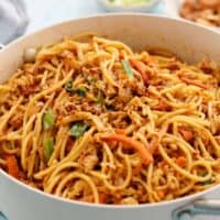 spicy thai noodles in a white pan.