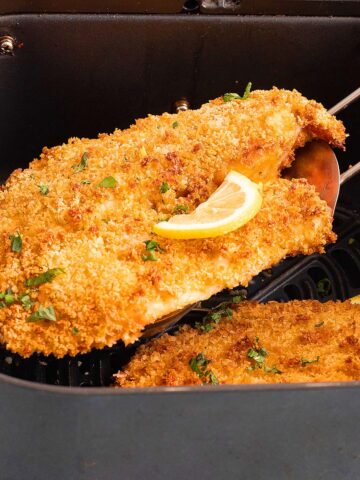 one breaded fish fillet with a slice of lemon.