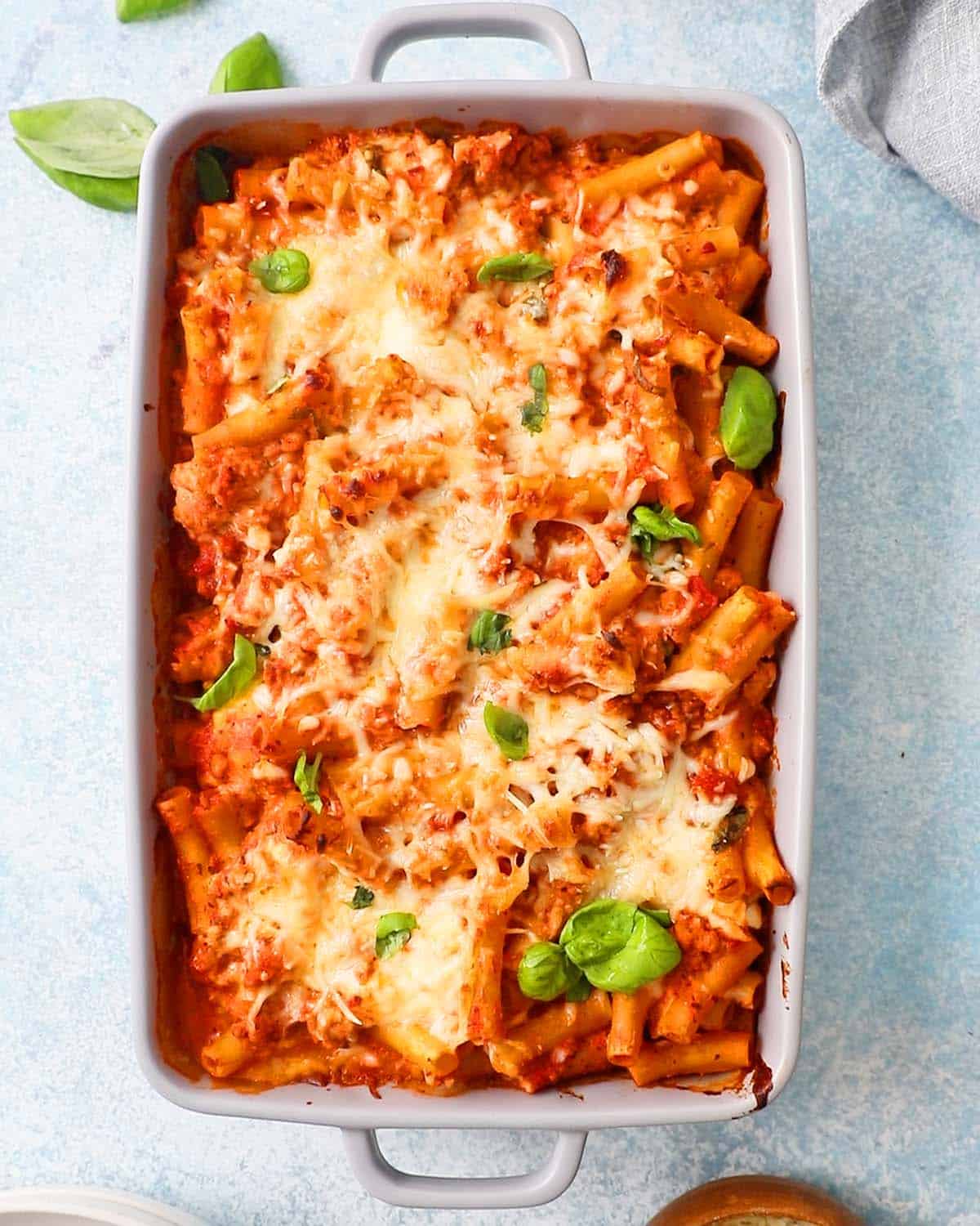 baked ziti pasta in a grey casserole dish.