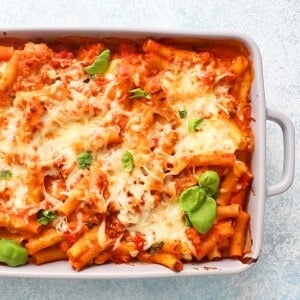 baked ziti pasta in a light grey casserole dish.