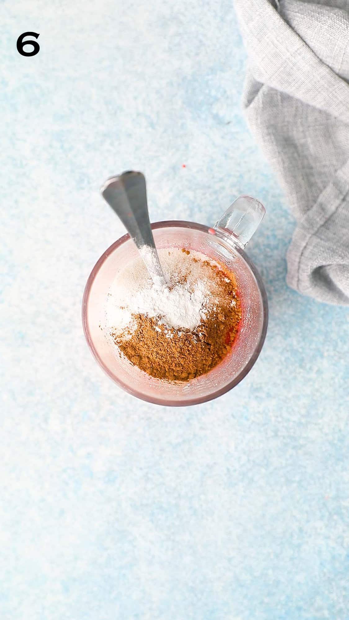 glass mug with flour, sugar and cocoa powder.