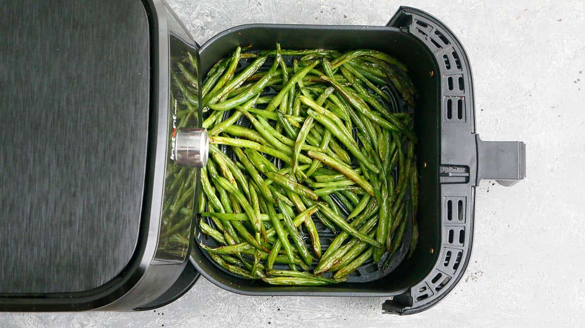 an open instant pot with cooked green beans