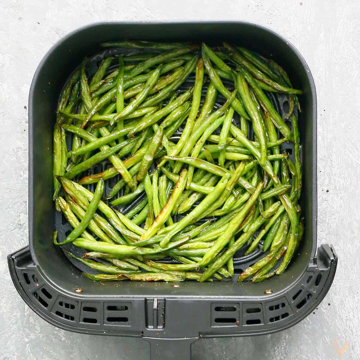 air fryer basket with crispy green beans