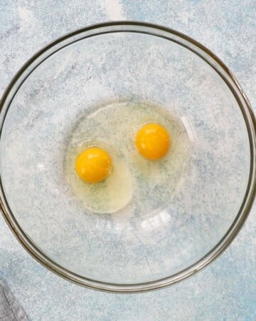 one large glass bowl with two eggs.