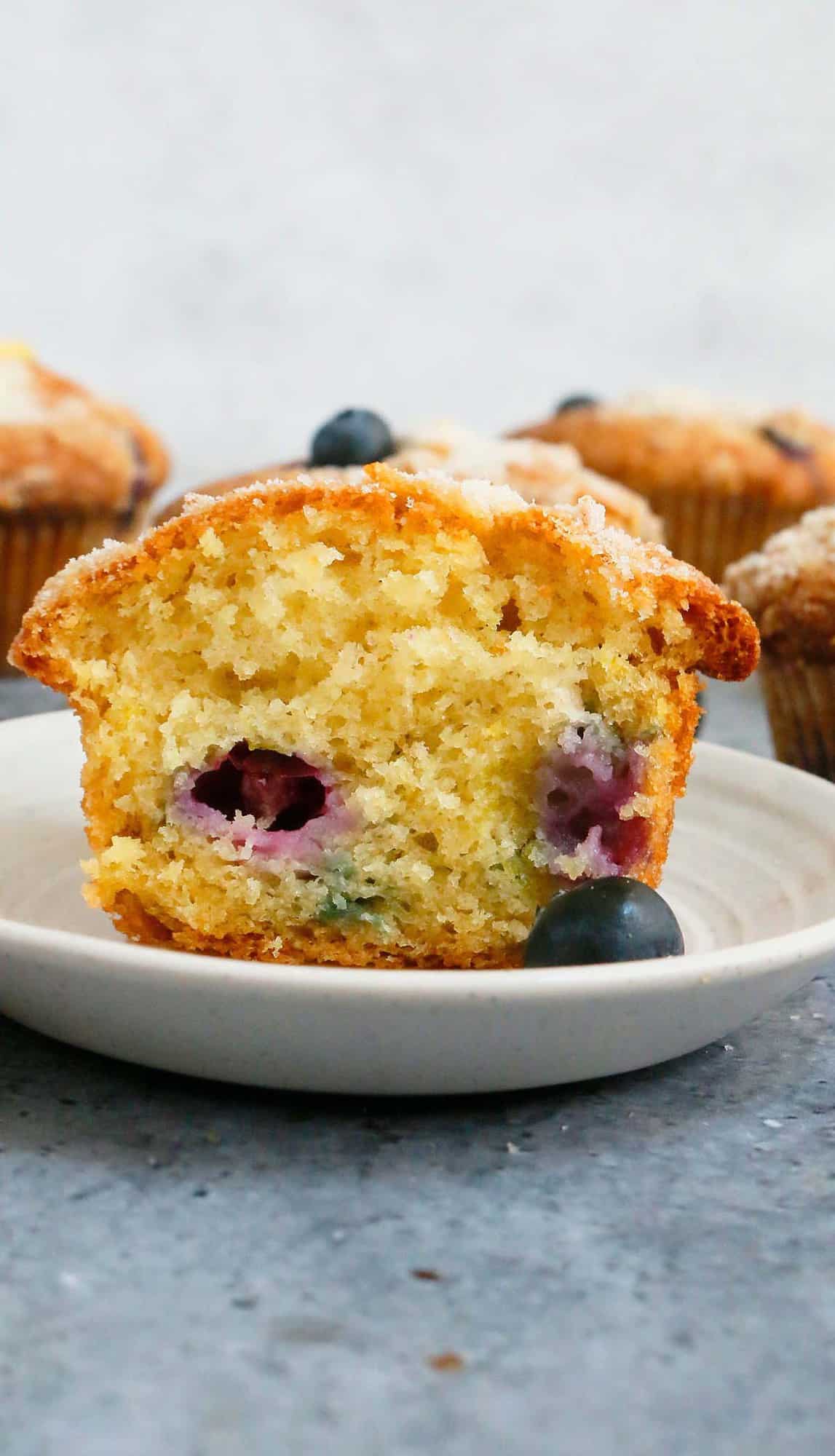 cross section of a lemon blueberry muffin placed on a white plate