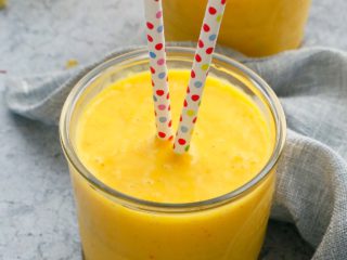 creamy mango milk in glasses along with a paper straws