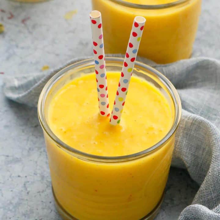 creamy mango milk in glasses along with a paper straws