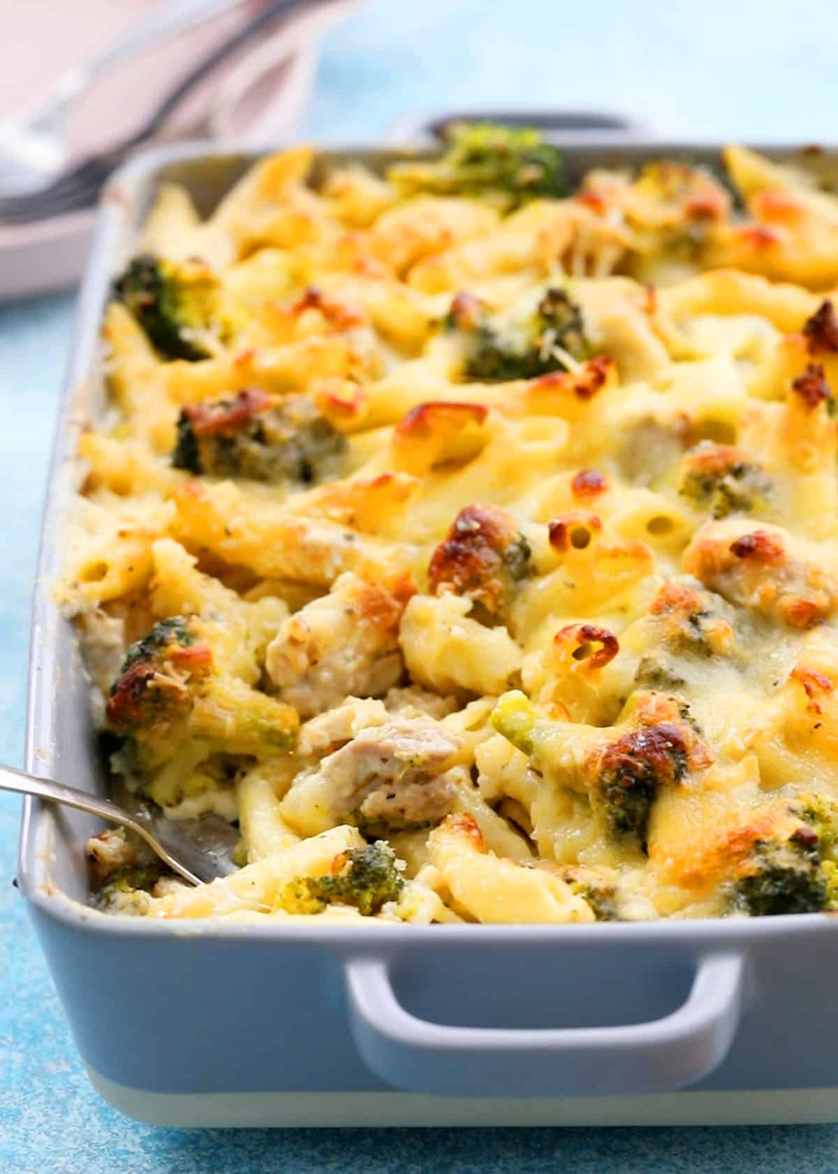 baked pasta chicken broccoli in a grey dish.