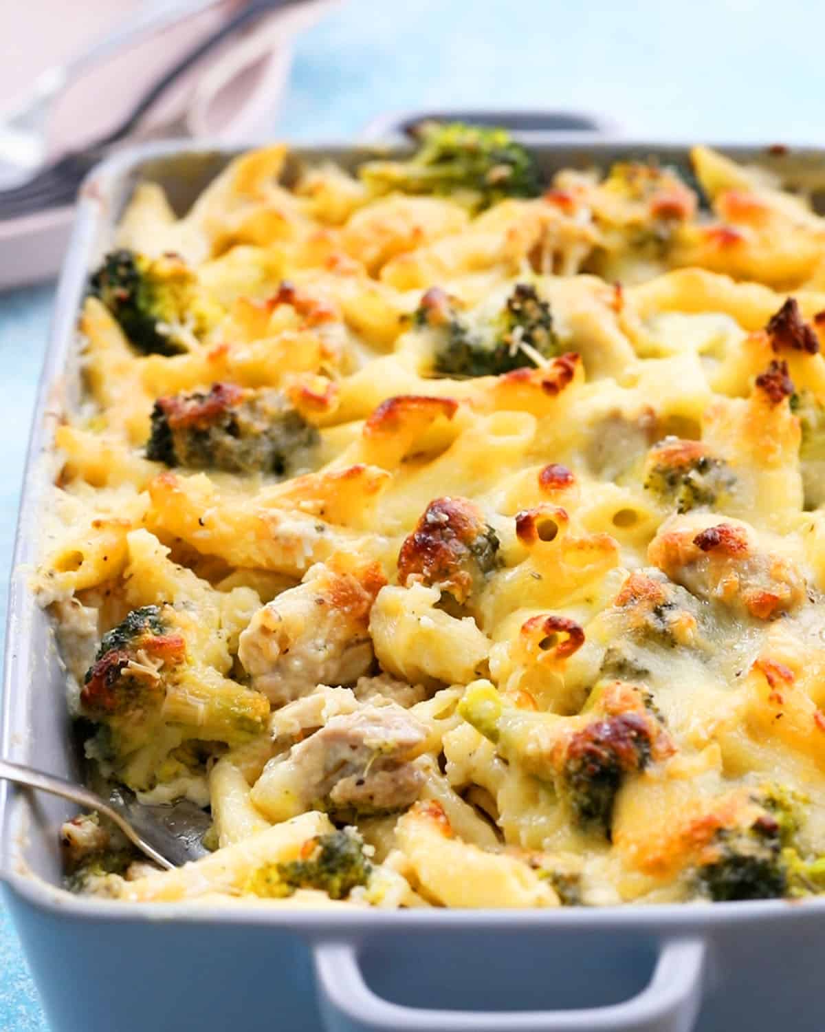 baked pasta chicken broccoli in a grey dish.