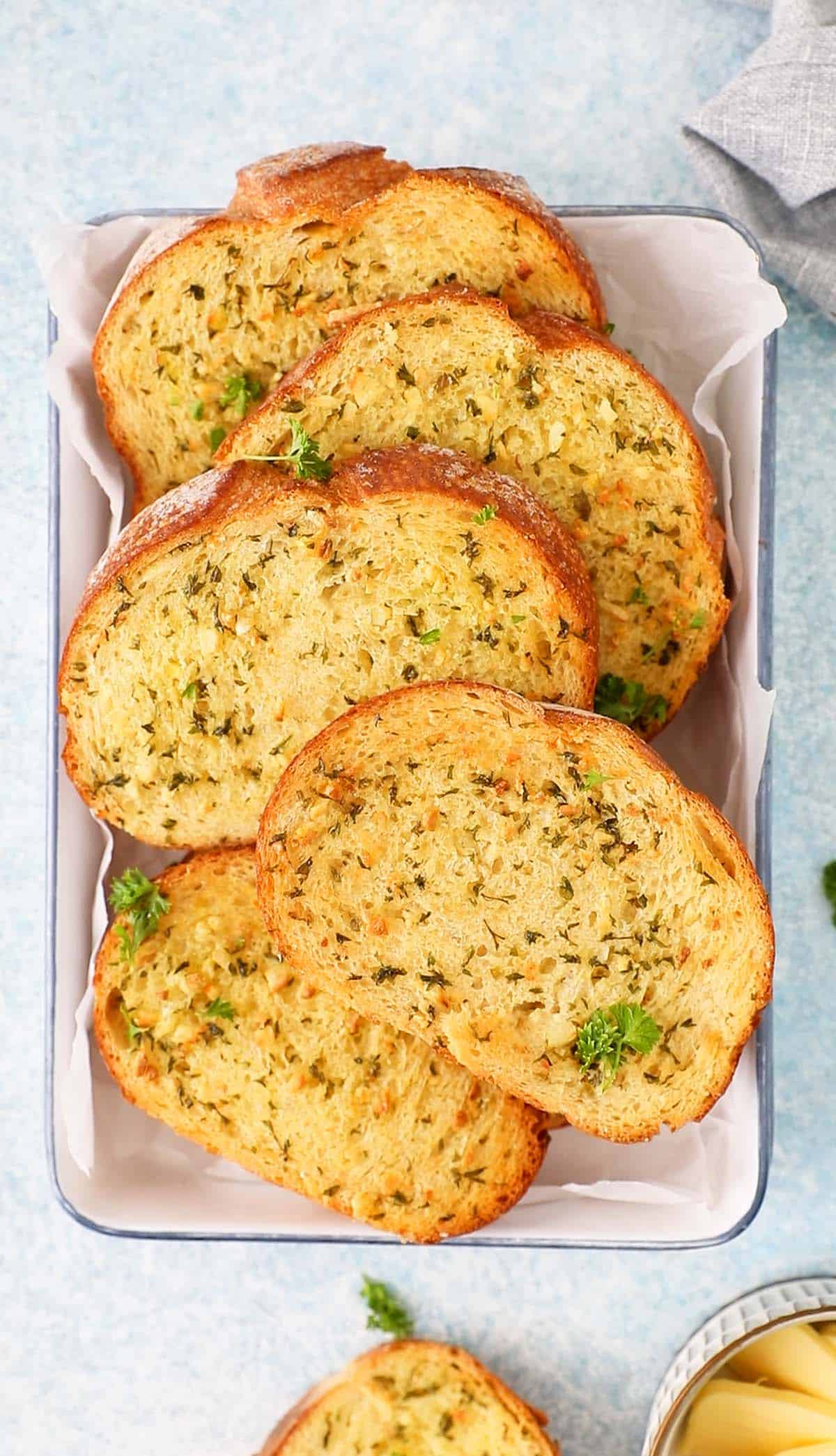 toasted garlic bread slices on a white tray.