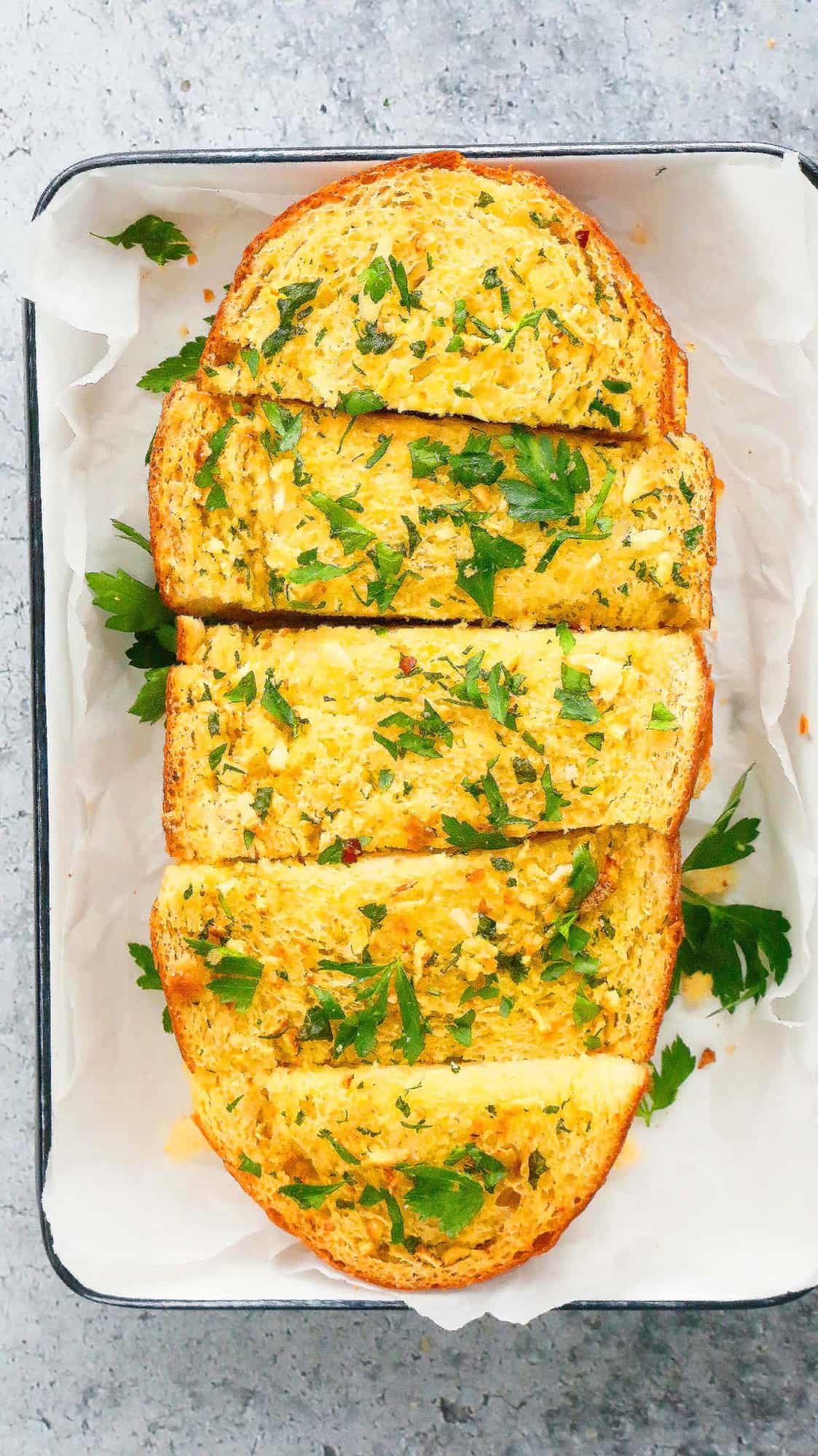 sliced air fryer garlic bread made from scratch placed on a white tray 