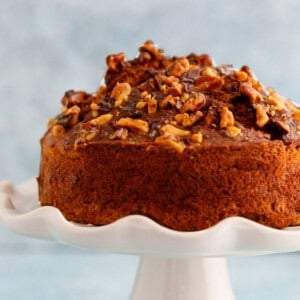 one air fryer banana cake placed on a white cake stand.