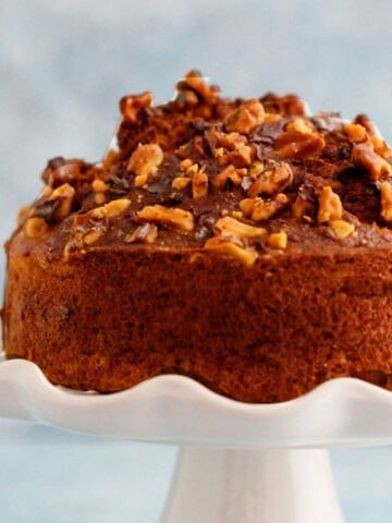 one air fryer banana cake placed on a white cake stand.