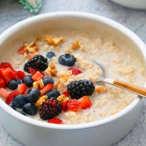 air fryer oatmeal in a pan topped with berries