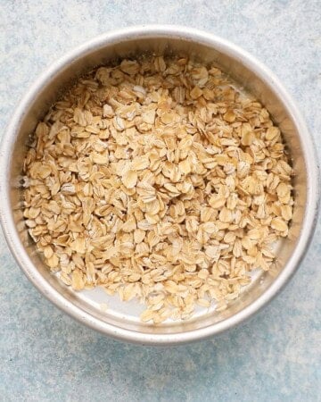 raw oats in a round metal pan.